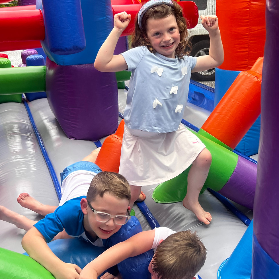 Children playing on a Jungle Rentals inflatable attraction