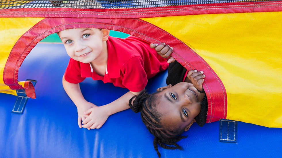 Child enjoying an inflatable obstacle course rental at a backyard party